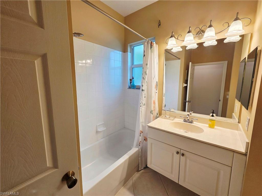 6775 Huntington Lakes Circle, Unit 202 Naples, FL 34119 - Photo 29 of 46 a bathroom with a tub sink and mirror