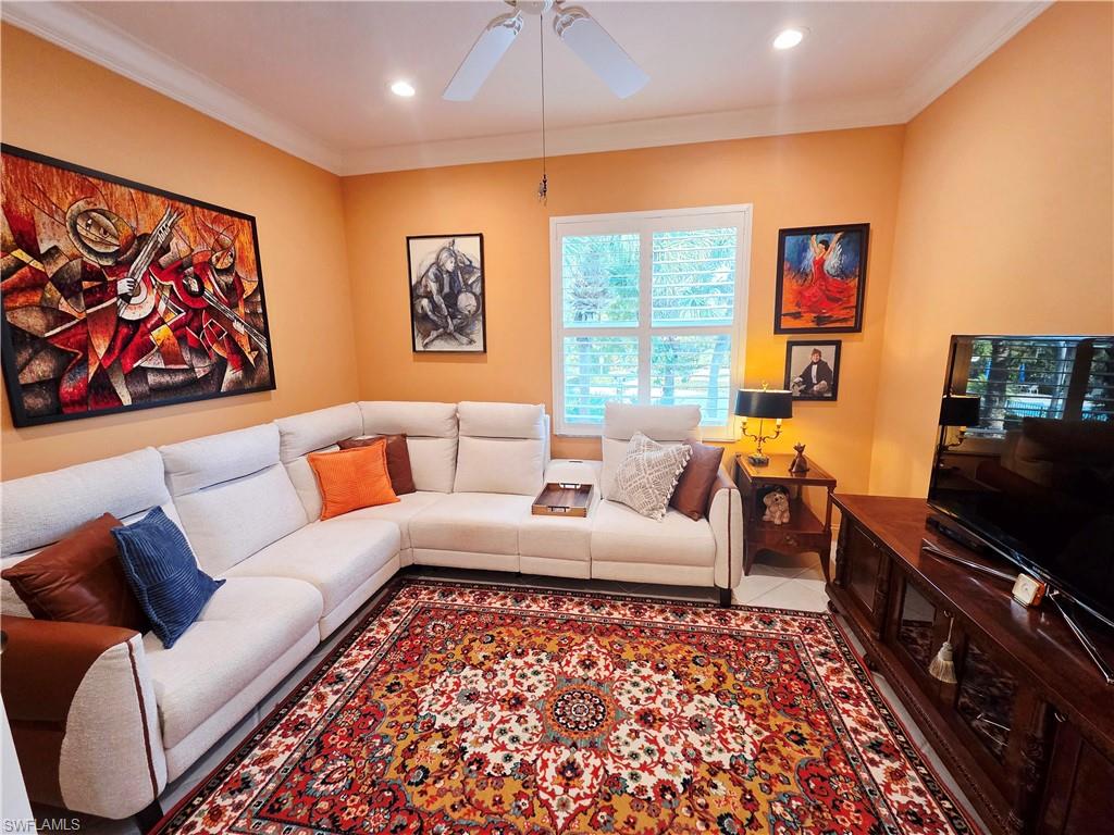6775 Huntington Lakes Circle, Unit 202 Naples, FL 34119 - Photo 31 of 46 a living room with furniture a rug and a flat screen tv