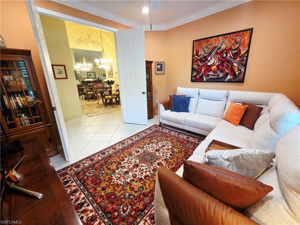 6775 Huntington Lakes Circle, Unit 202 Naples, FL 34119 - Photo 32 of 46 a living room with furniture and a rug