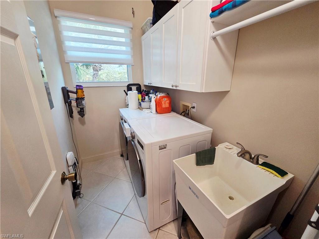6775 Huntington Lakes Circle, Unit 202 Naples, FL 34119 - Photo 34 of 46 a utility room with dryer and washer