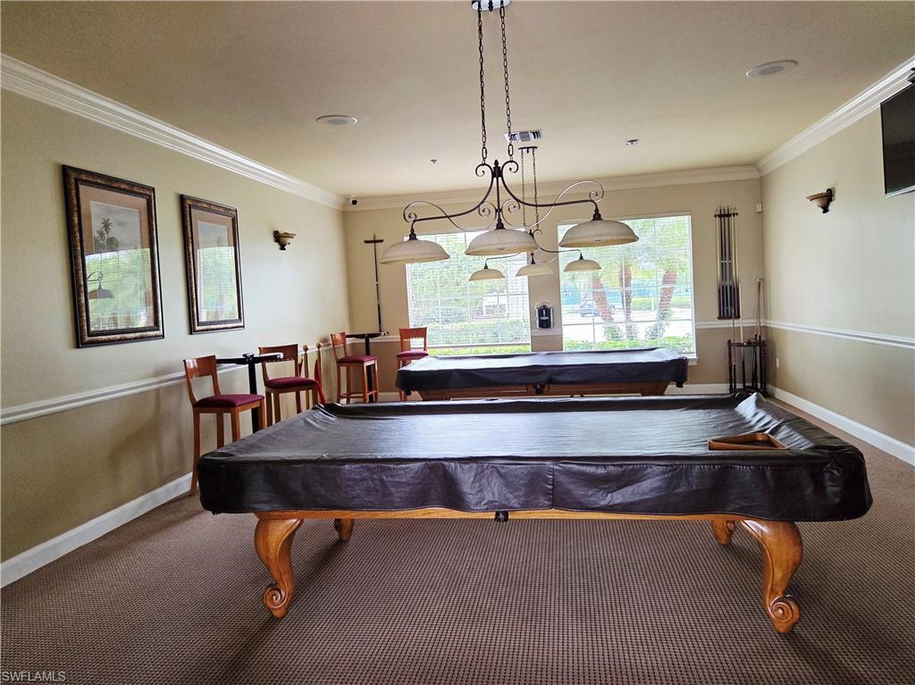 6775 Huntington Lakes Circle, Unit 202 Naples, FL 34119 - Photo 40 of 46 a room with wooden floor pool table and windows