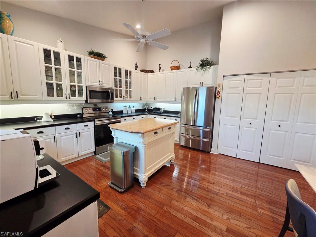 6775 Huntington Lakes Circle, Unit 202 Naples, FL 34119 - Photo 4 of 46 a kitchen with stainless steel appliances a stove a refrigerator and cabinets