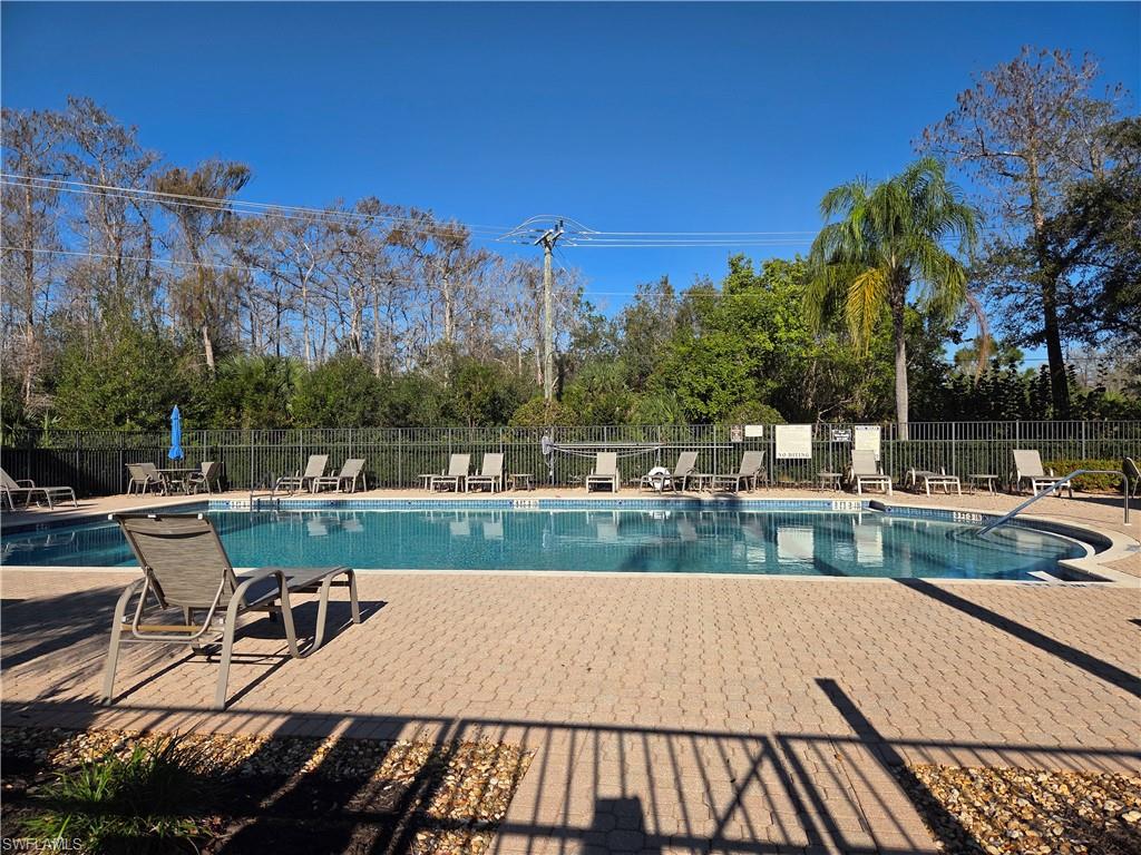 6775 Huntington Lakes Circle, Unit 202 Naples, FL 34119 - Photo 41 of 46 a view of a swimming pool with a patio and a yard