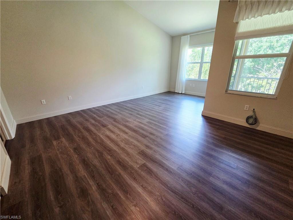 6775 Huntington Lakes Circle, Unit 202 Naples, FL 34119 - Photo 6 of 46 a view of an empty room and wooden floor