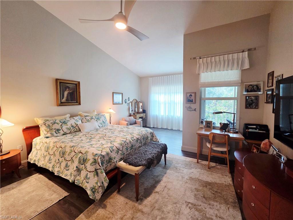6775 Huntington Lakes Circle, Unit 202 Naples, FL 34119 - Photo 8 of 46 a bedroom with a bed and wooden floor