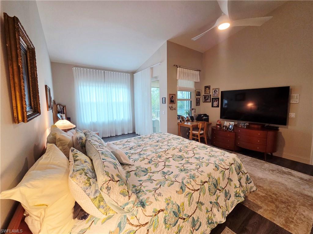 6775 Huntington Lakes Circle, Unit 202 Naples, FL 34119 - Photo 9 of 46 a bedroom with a bed and a flat screen tv