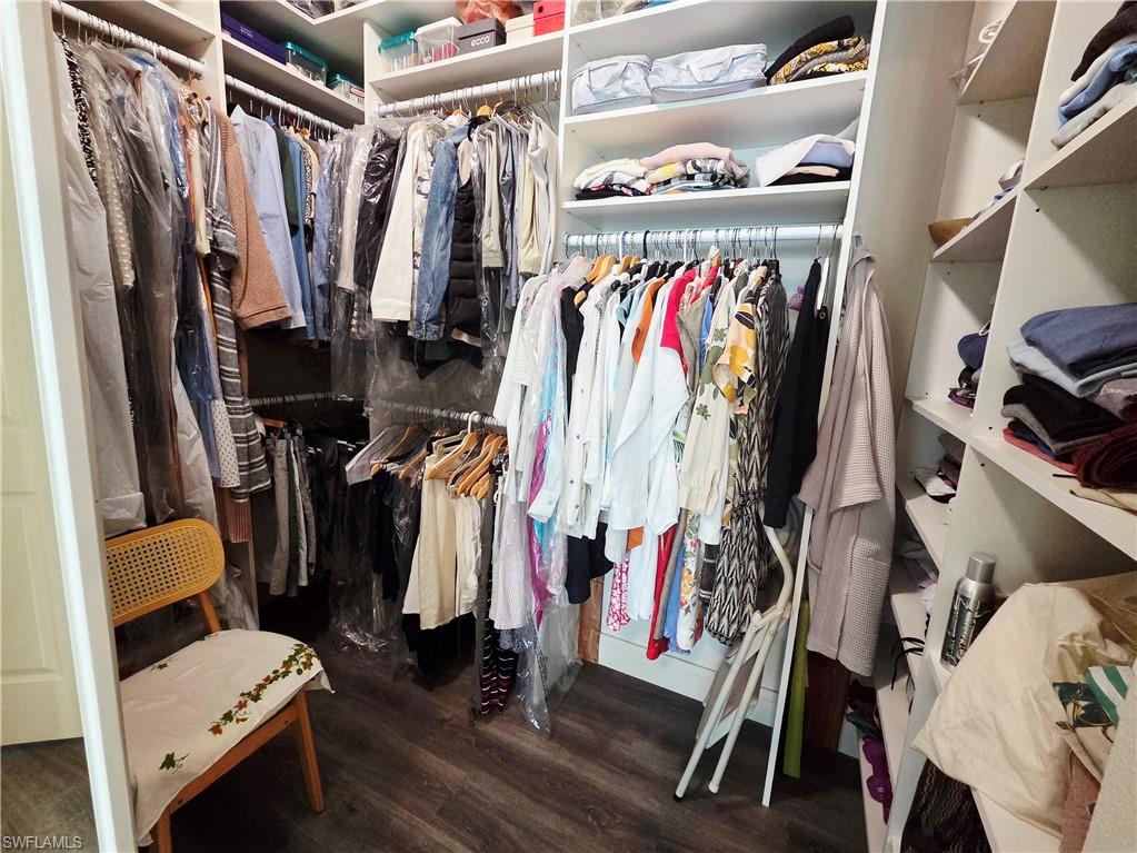 6775 Huntington Lakes Circle, Unit 202 Naples, FL 34119 - Photo 10 of 46 a view of walk in closet with clothes and shoes
