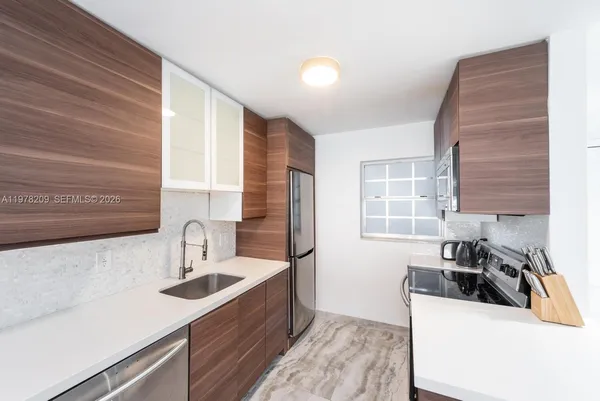 a kitchen that has a sink and a stove