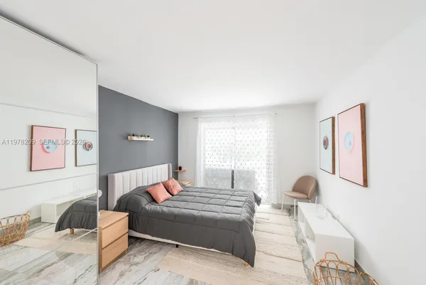 a bedroom with a bed and a couch