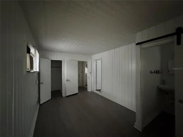 a view of a kitchen and an empty room with a kitchen