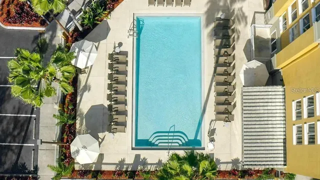 a view of a swimming pool and lounge chairs