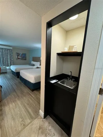 a kitchen with sink and refrigerator