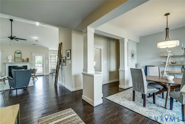 a dining room with furniture a chandelier and wooden floor