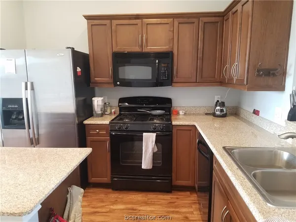 a kitchen with a sink stove and microwave
