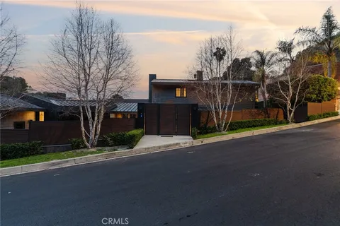 a street view of a house next to a yard