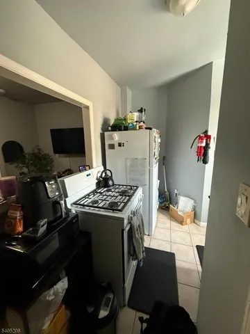 a kitchen with a stove and a refrigerator