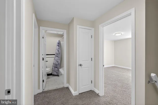 a view of a bathroom with a toilet and a mirror