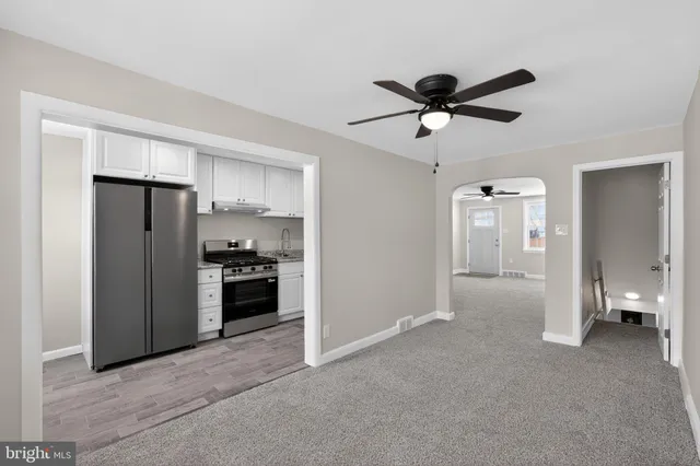 a view of a kitchen with a sink and a refrigerator