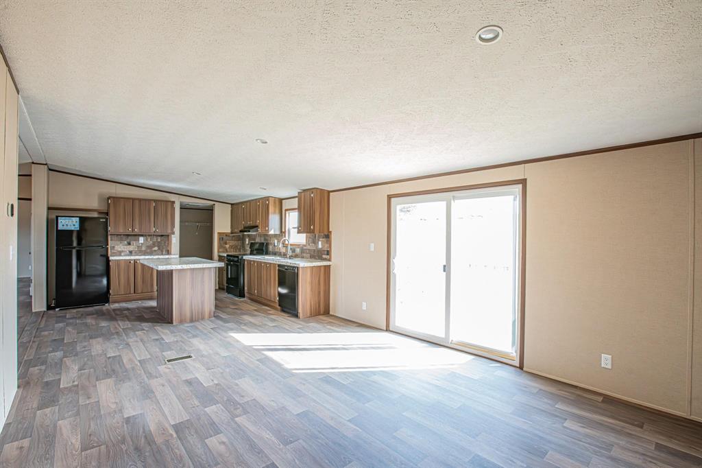 109 Draven Drive Springtown, TX 76082 - Photo 11 of 35 a view of a kitchen with wooden floor and a sink