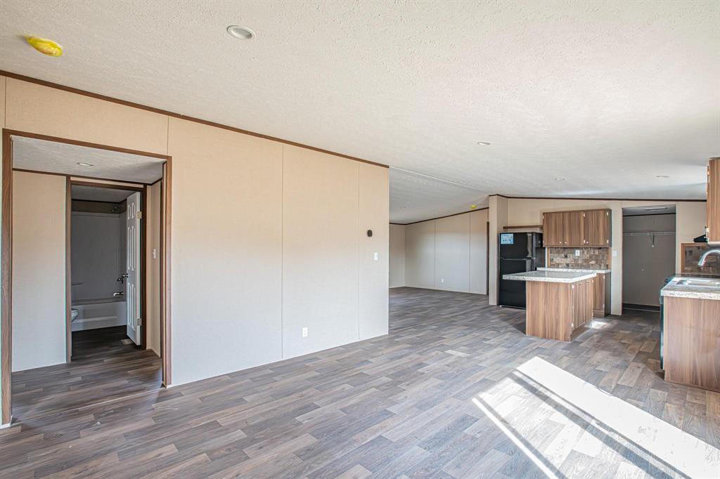 109 Draven Drive Springtown, TX 76082 - Photo 12 of 35 a view of a kitchen with a sink and a refrigerator