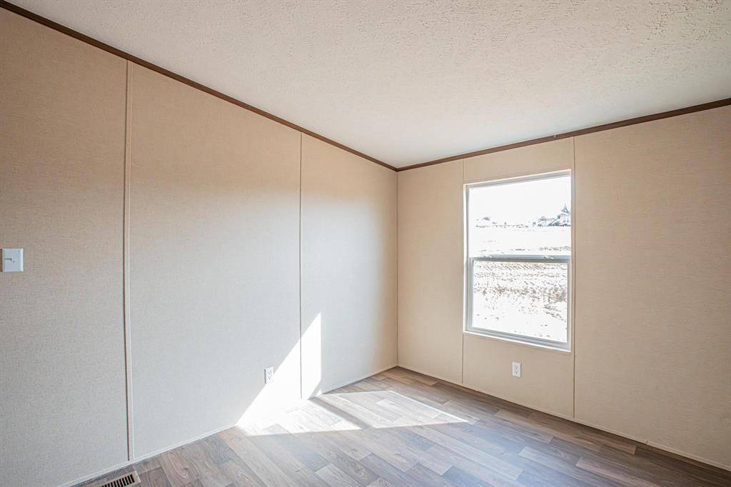 109 Draven Drive Springtown, TX 76082 - Photo 17 of 35 an empty room with wooden floor closet and windows