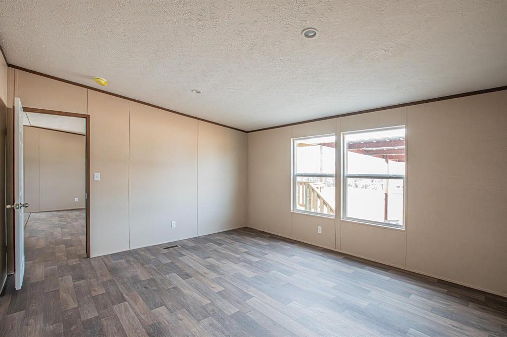 109 Draven Drive Springtown, TX 76082 - Photo 32 of 35 an empty room with wooden floor and windows