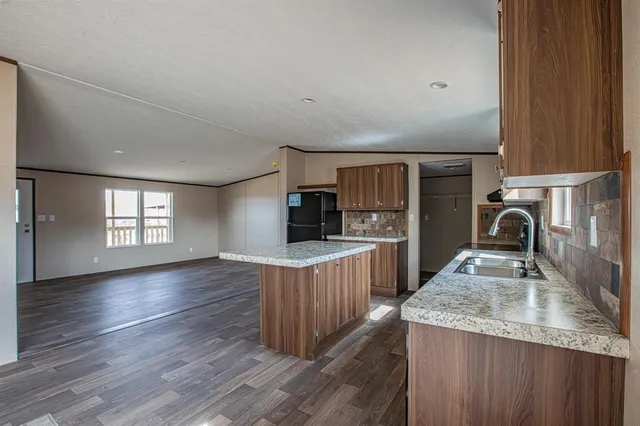 a kitchen with sink cabinets and wooden floor