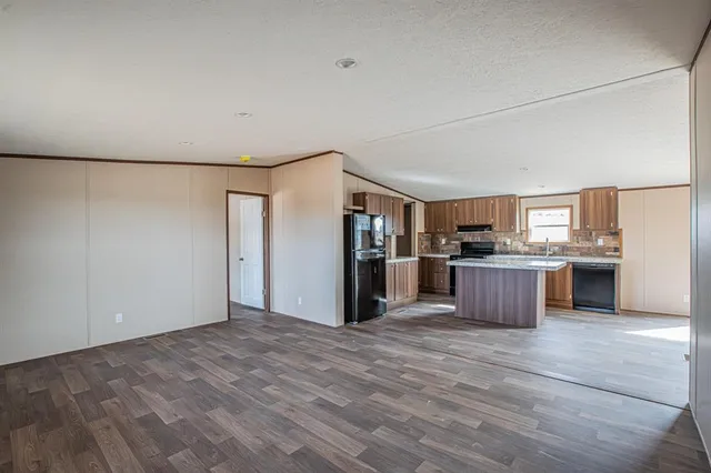 a view of kitchen with stainless steel appliances kitchen island a refrigerator and a stove