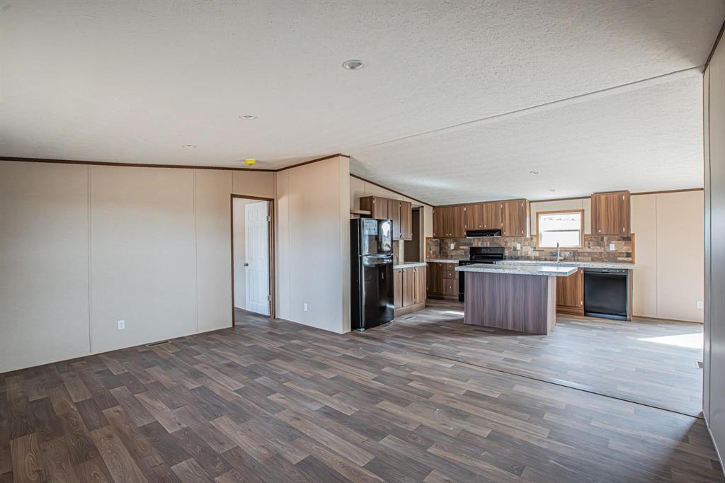 109 Draven Drive Springtown, TX 76082 - Photo 8 of 35 a view of kitchen with stainless steel appliances kitchen island a refrigerator and a stove