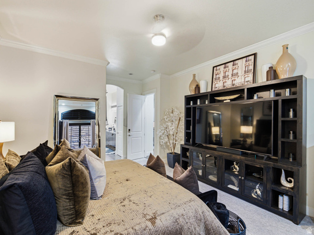 1154 Sunset Dunes Way Draper, UT 84020 - Photo 25 of 50 Bedroom with crown molding, ensuite bath, carpet, ceiling fan, and arched walkways