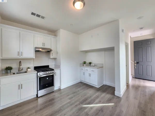 a kitchen with granite countertop a stove and a sink