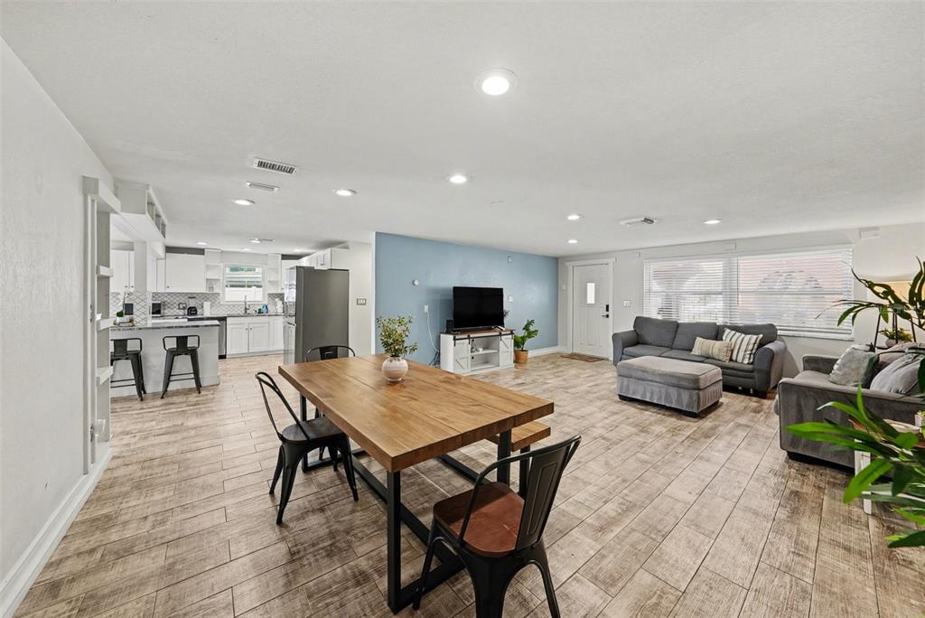 8828 Carmen Lane Port Richey, FL 34668 - Photo 16 of 28 a living room with furniture and a flat screen tv