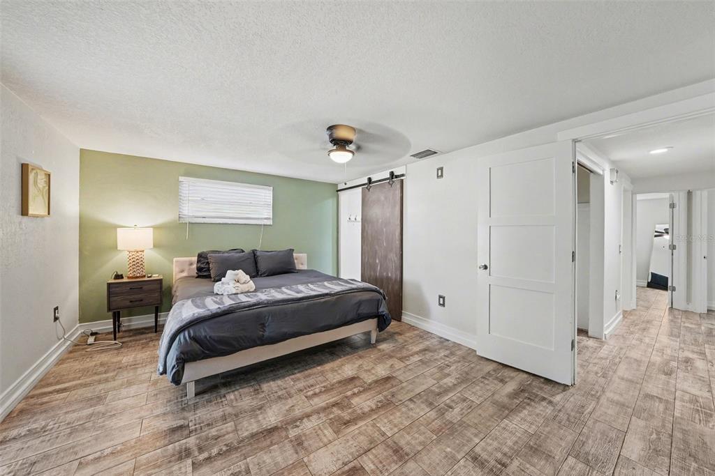 8828 Carmen Lane Port Richey, FL 34668 - Photo 17 of 28 a bedroom with a bed and a window