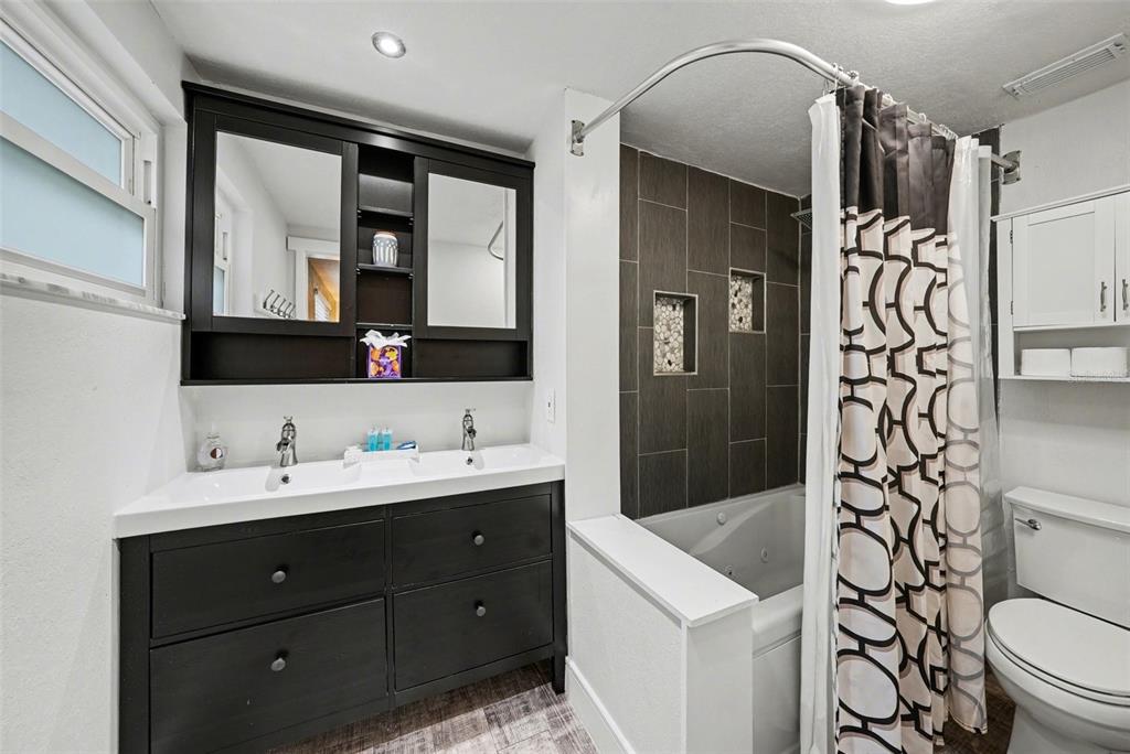 8828 Carmen Lane Port Richey, FL 34668 - Photo 21 of 28 a bathroom with a sink a toilet and shower