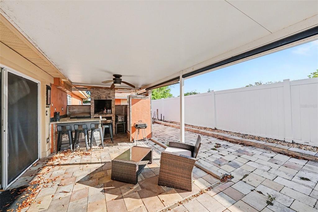 8828 Carmen Lane Port Richey, FL 34668 - Photo 22 of 28 a outdoor space with lots of tables a mirror and chandelier