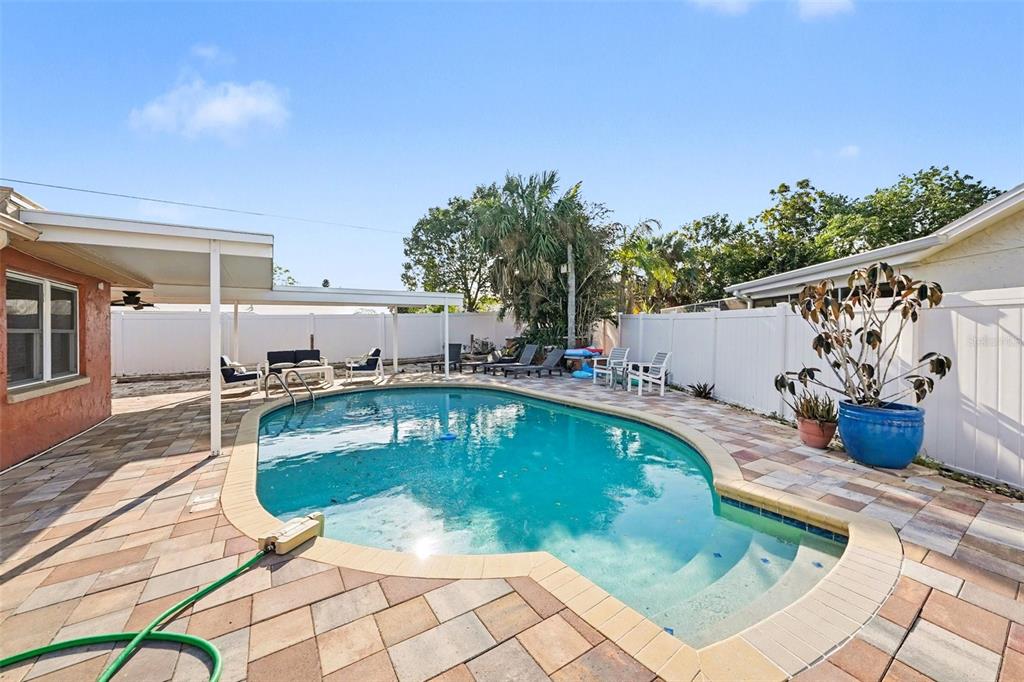 8828 Carmen Lane Port Richey, FL 34668 - Photo 27 of 28 a view of a swimming pool with a patio