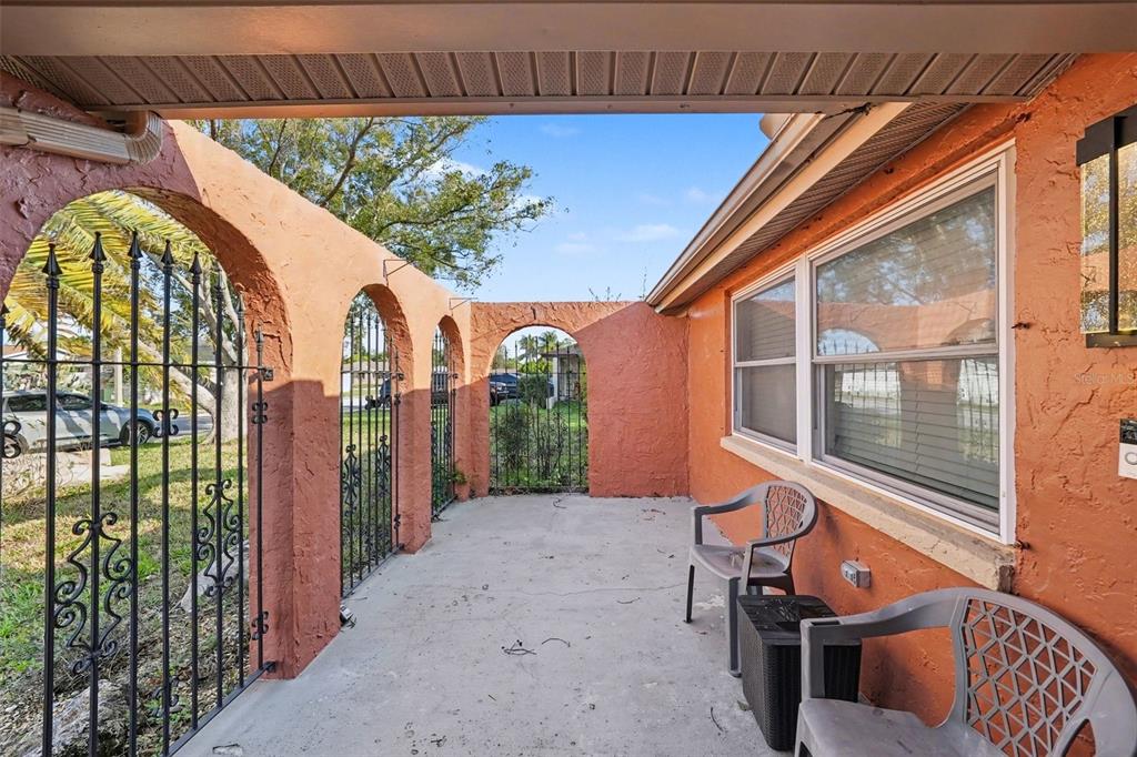 8828 Carmen Lane Port Richey, FL 34668 - Photo 3 of 28 a view of a porch with a table and chairs
