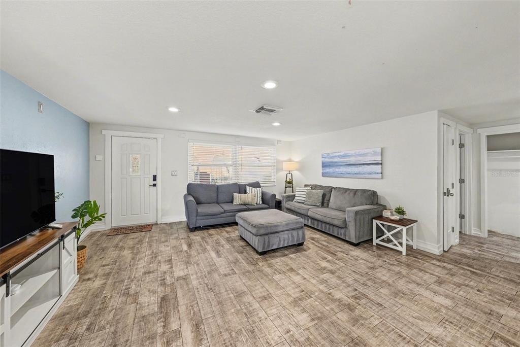 8828 Carmen Lane Port Richey, FL 34668 - Photo 5 of 28 a living room with furniture and a flat screen tv