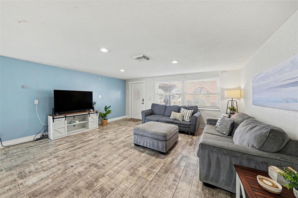 8828 Carmen Lane Port Richey, FL 34668 - Photo 6 of 28 a living room with furniture and a flat screen tv
