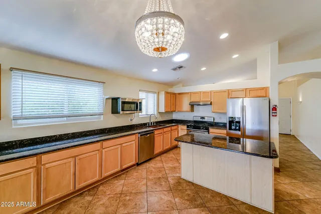 a kitchen with stainless steel appliances granite countertop a sink and cabinets