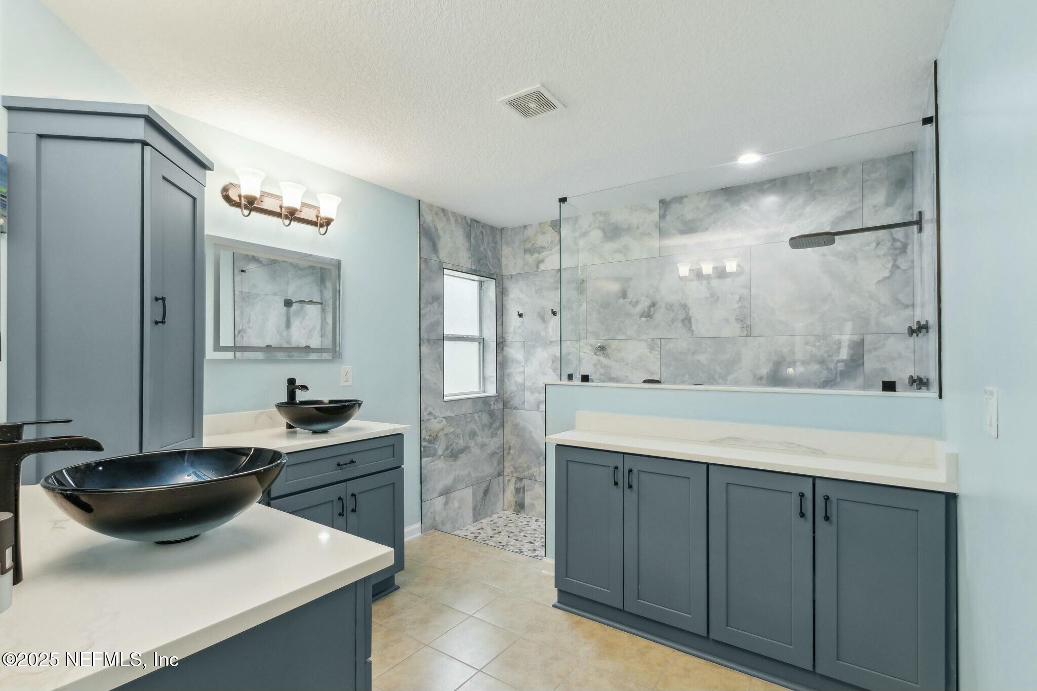 86197 Fortune Drive Yulee, FL 32097 - Photo 17 of 36 a bathroom with a sink a toilet a mirror and shower