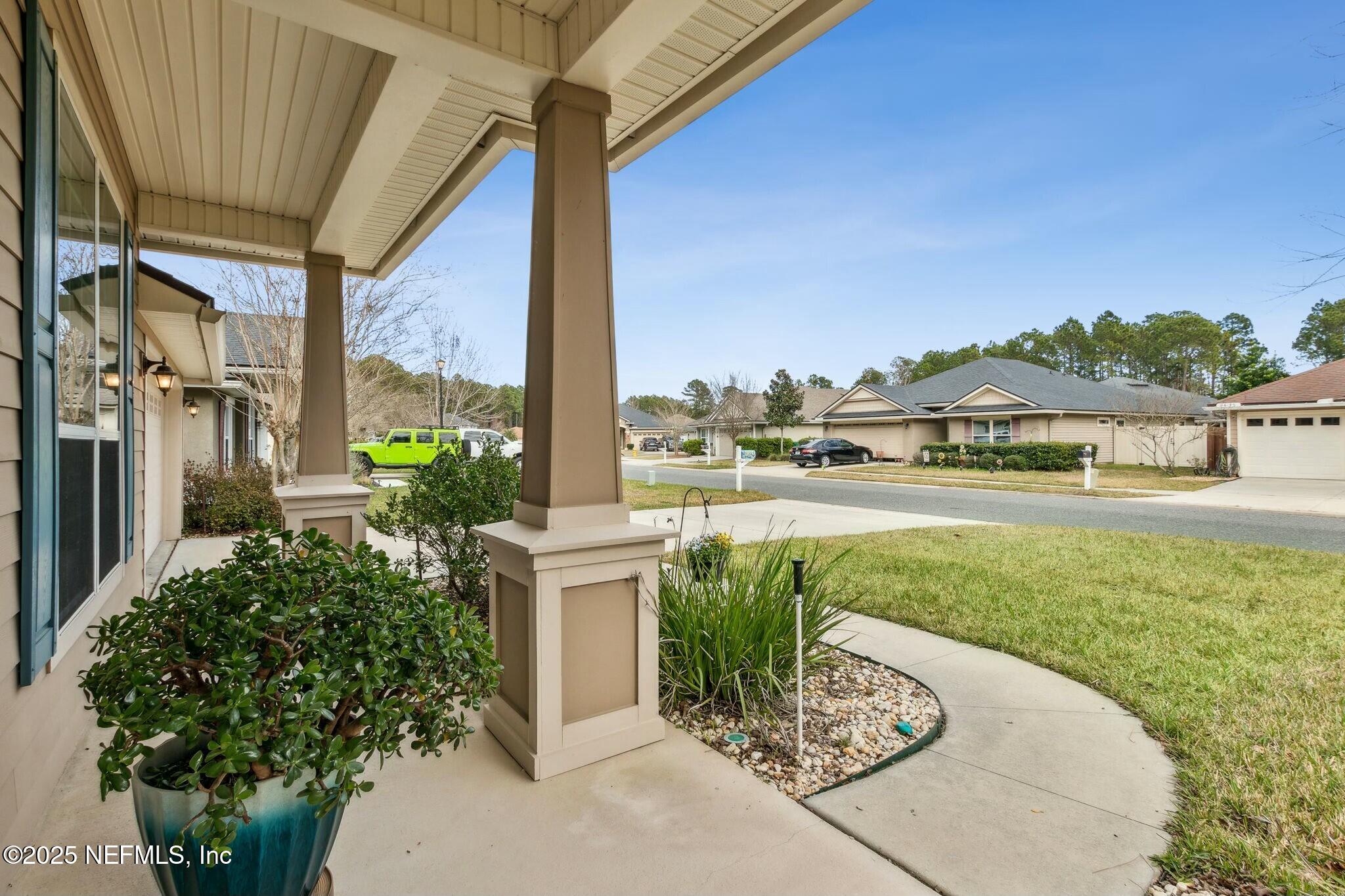 86197 Fortune Drive Yulee, FL 32097 - Photo 2 of 36 a view of a porch with furniture and a yard