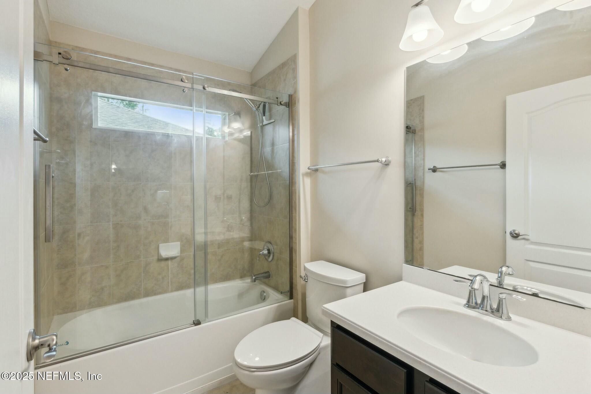 86197 Fortune Drive Yulee, FL 32097 - Photo 21 of 36 a bathroom with a sink a toilet and shower