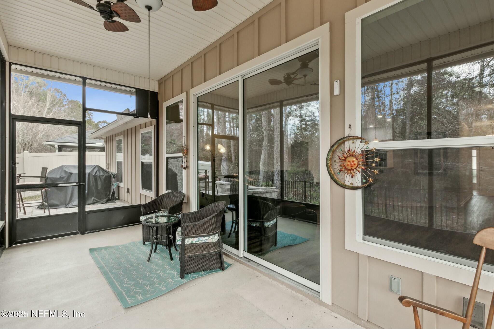 86197 Fortune Drive Yulee, FL 32097 - Photo 26 of 36 a view of living room with furniture and floor to ceiling window
