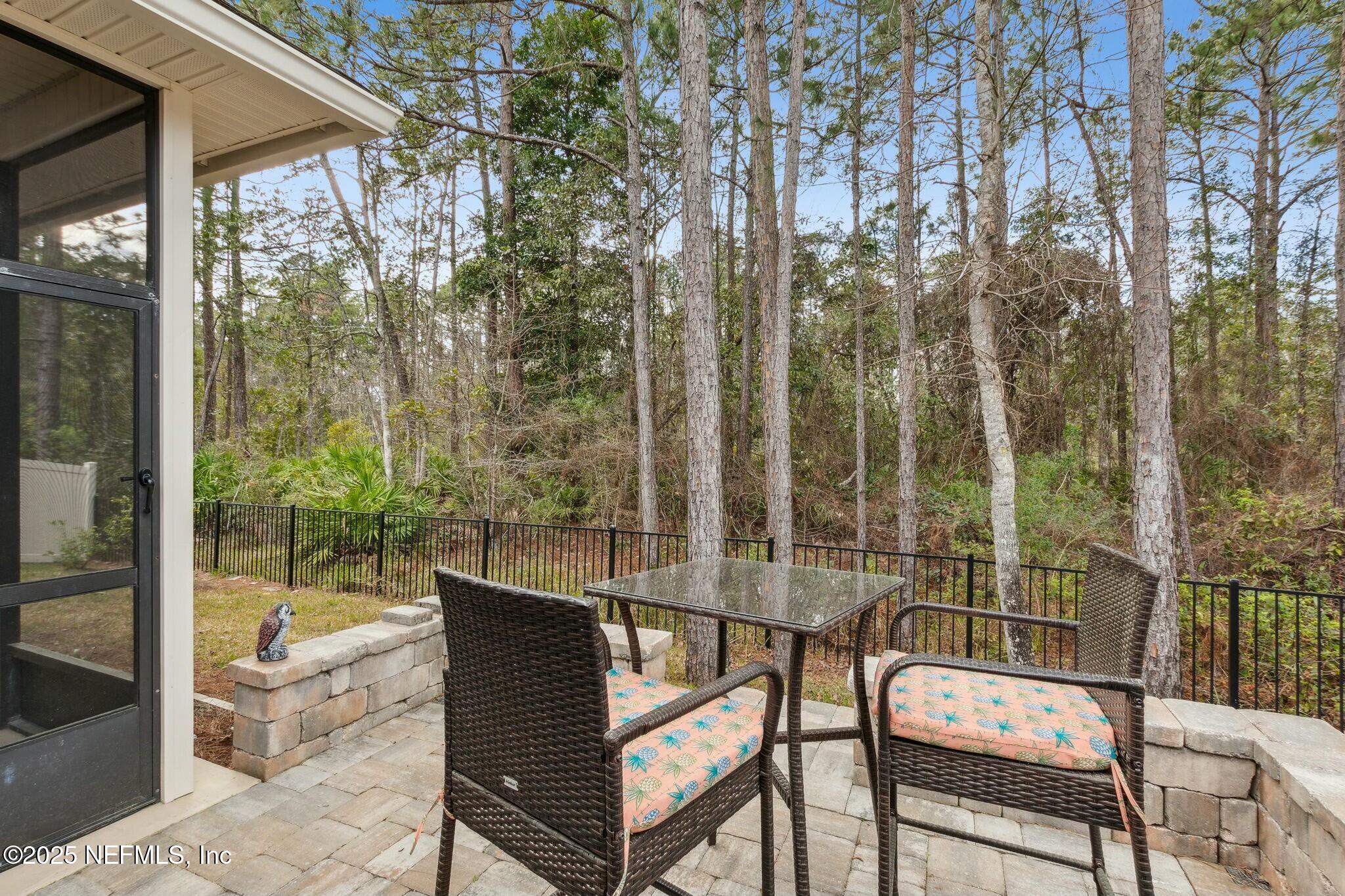 86197 Fortune Drive Yulee, FL 32097 - Photo 29 of 36 a view of a chair and tables in the balcony