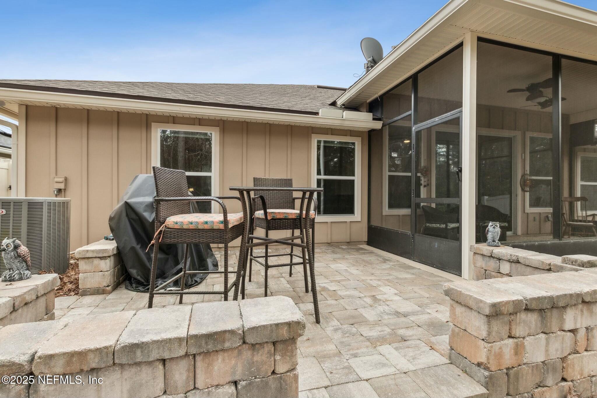 86197 Fortune Drive Yulee, FL 32097 - Photo 30 of 36 a view of a patio with table and chairs and potted plants