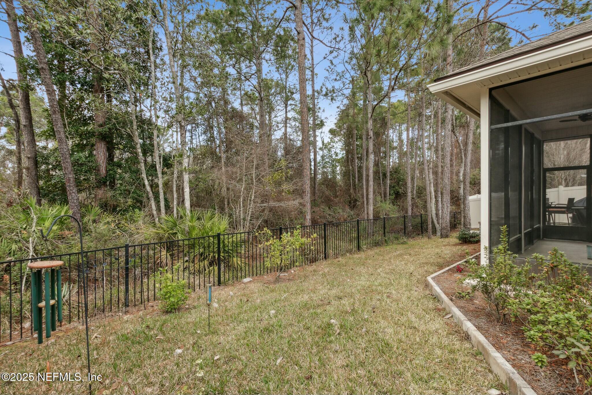 86197 Fortune Drive Yulee, FL 32097 - Photo 32 of 36 a backyard of a house with lots of green space and fountain