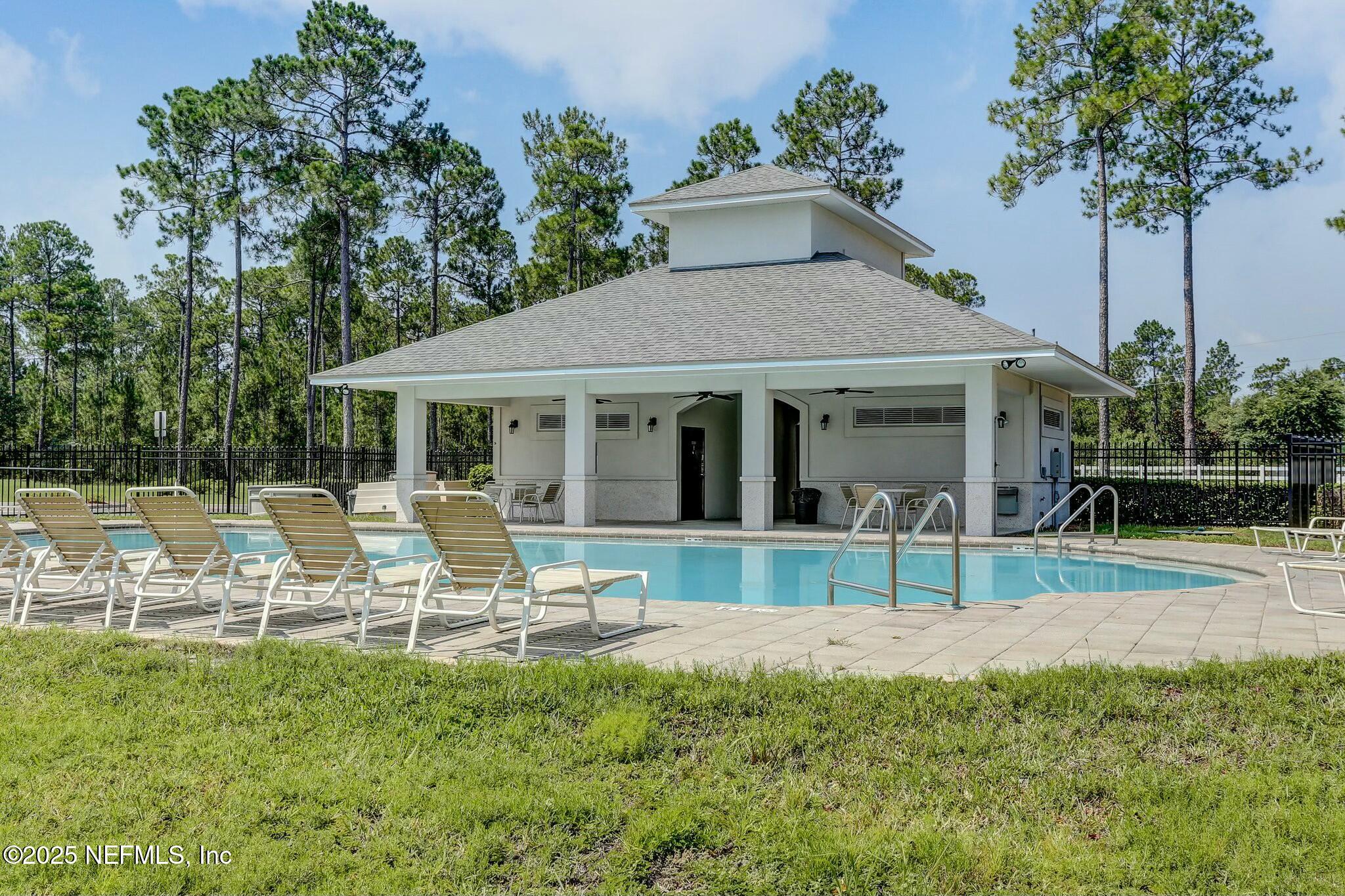 86197 Fortune Drive Yulee, FL 32097 - Photo 33 of 36 a front view of house with a garden and patio