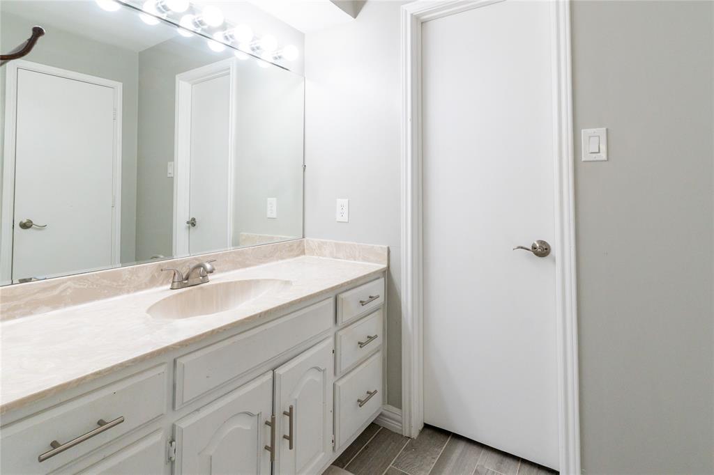 1246 Meadow Way Terrell, TX 75160 - Photo 12 of 39 a spacious bathroom with a double vanity sink and mirror
