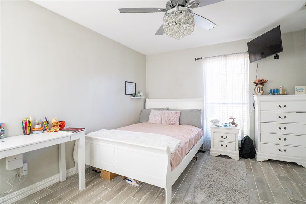 1246 Meadow Way Terrell, TX 75160 - Photo 16 of 39 a bedroom with a bed and a flat screen tv